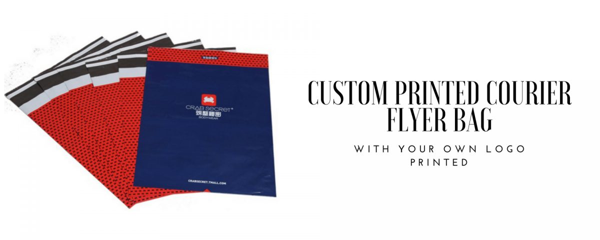 A stack of courier bags, some red with a black dot pattern and a black and white striped flap, and one dark blue bag with a red logo and text.