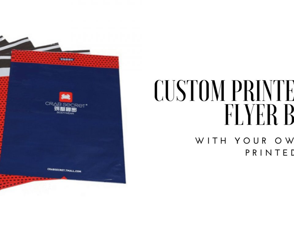 A stack of courier bags, some red with a black dot pattern and a black and white striped flap, and one dark blue bag with a red logo and text.