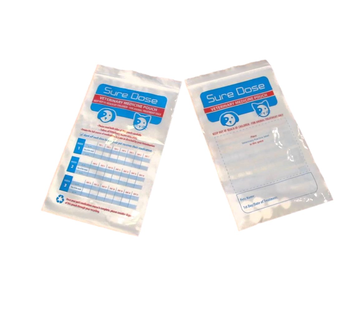 Two clear plastic pouches with blue and red printing. The left pouch has a grid for tracking medication doses by week. The right pouch has fields for pet name and treatment start date.