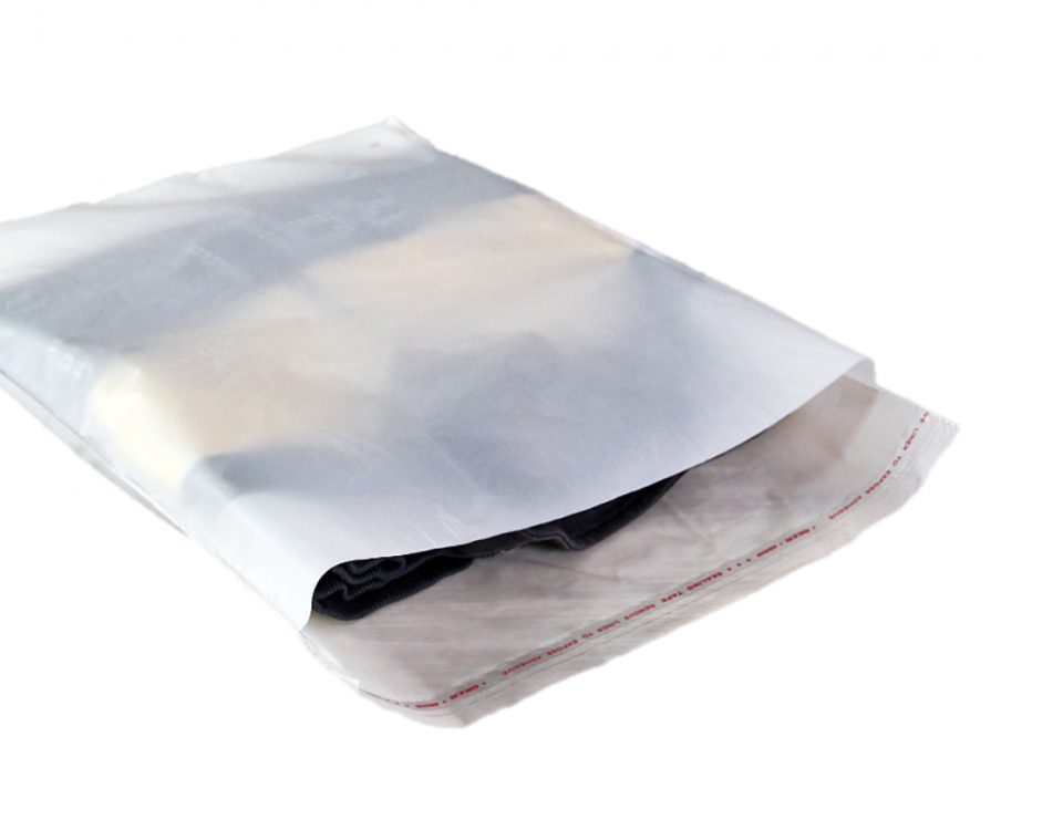 A clear poly mailer bag containing folded clothing items, with the flap open to reveal the contents and a red printed sealing strip.