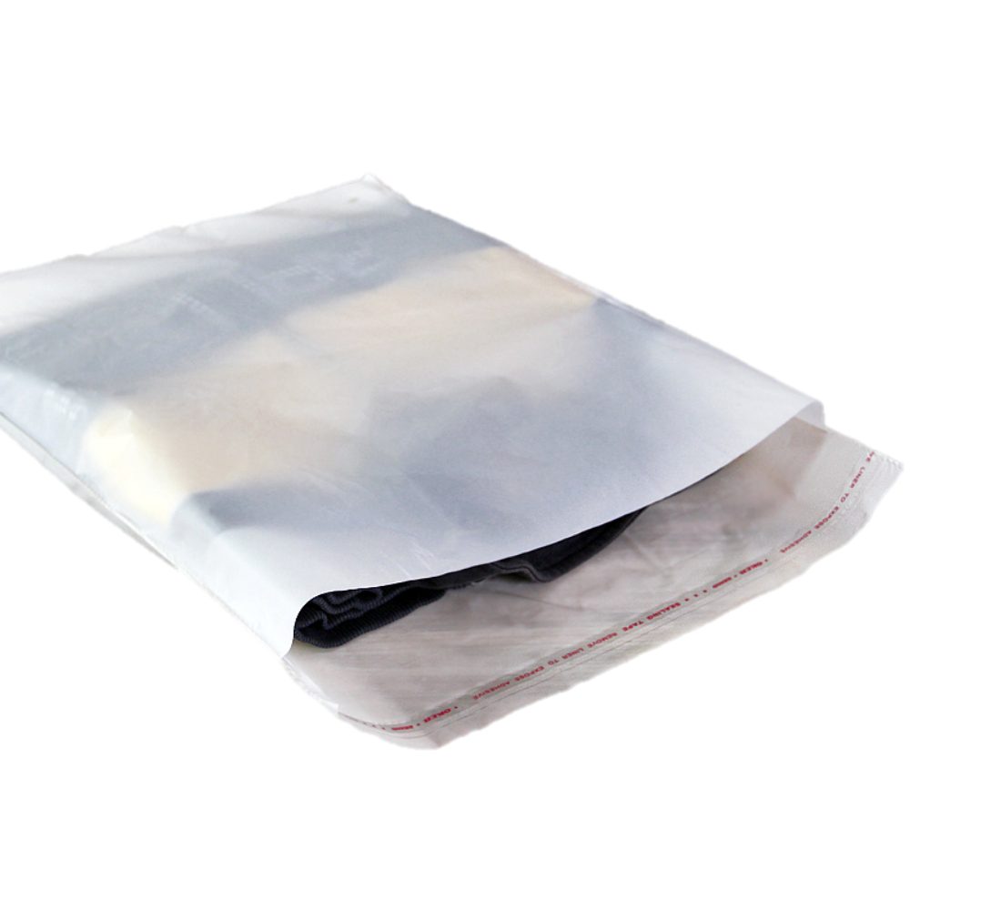 A clear poly mailer bag containing folded clothing items, with the flap open to reveal the contents and a red printed sealing strip.