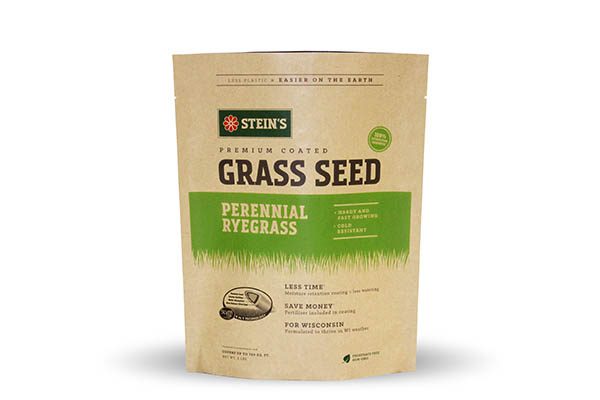 A stand-up pouch of grass seed with a kraft paper appearance. The front features green and brown text and graphics, including the brand name, product type, and specific grass variety.