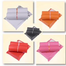 A collage of five different colored mailing envelopes. Each envelope is a flat, square-shaped mailer with a flap closure. The envelopes are shown in white, orange, black, red, and pink, with some appearing to contain rolled items inside.