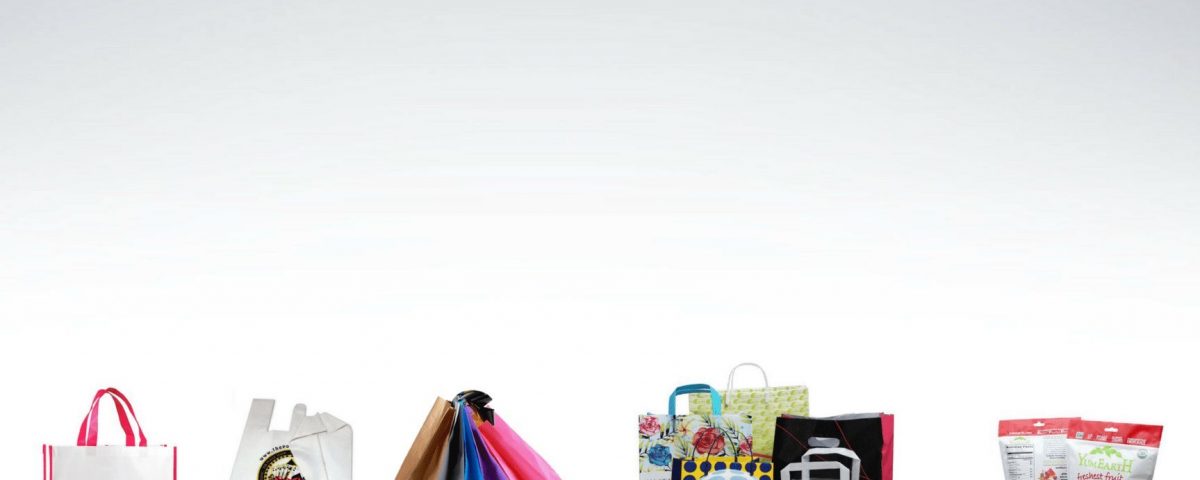 A collection of various retail bags and pouches displayed against a white background. Includes tote bags with handles, gusseted pouches with resealable closures, and flat bags with printed graphics.