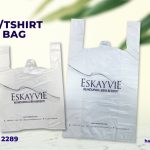 The image is an advertisement for "SINGLET/TSHIRT PLASTIC BAG" from Hain Packaging. The image features two white plastic