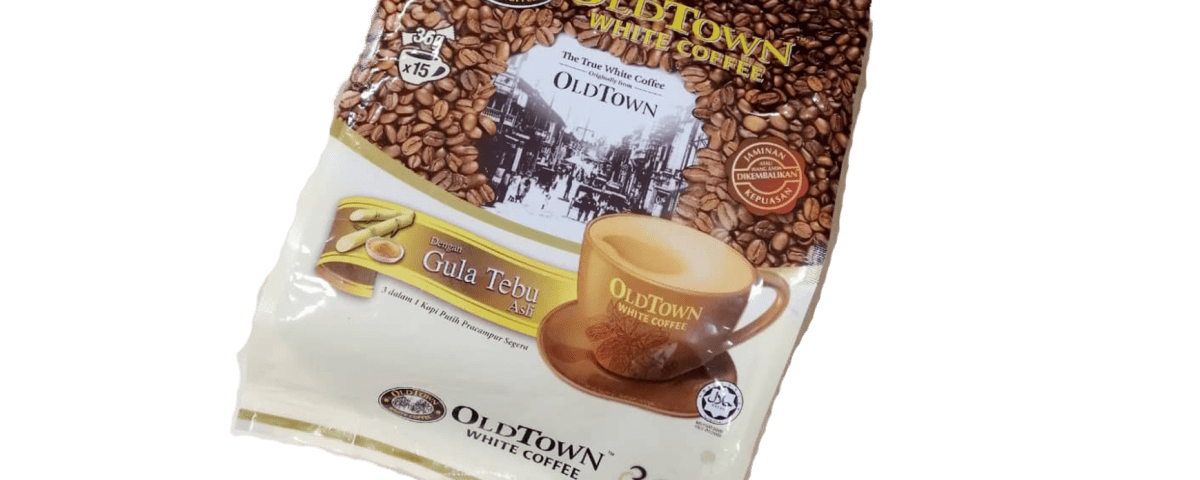 The picture shows a bag of Old Town White Coffee. The bag is made of a brown and white material, and it features a coffee bean pattern on