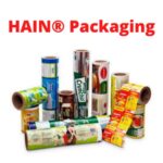 A collection of various flexible packaging rolls with colorful printed designs and text, arranged on a white background.
