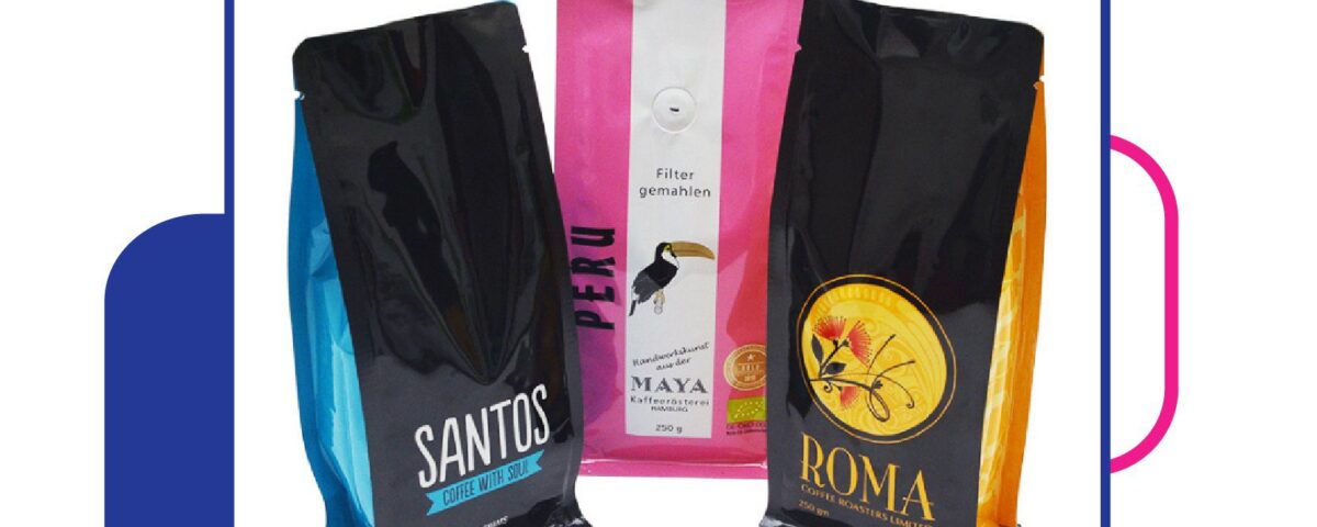 Three custom printed flat bottom pouches, two black with blue and orange accents, and one pink with white stripes, are displayed. The pouches appear to contain coffee.