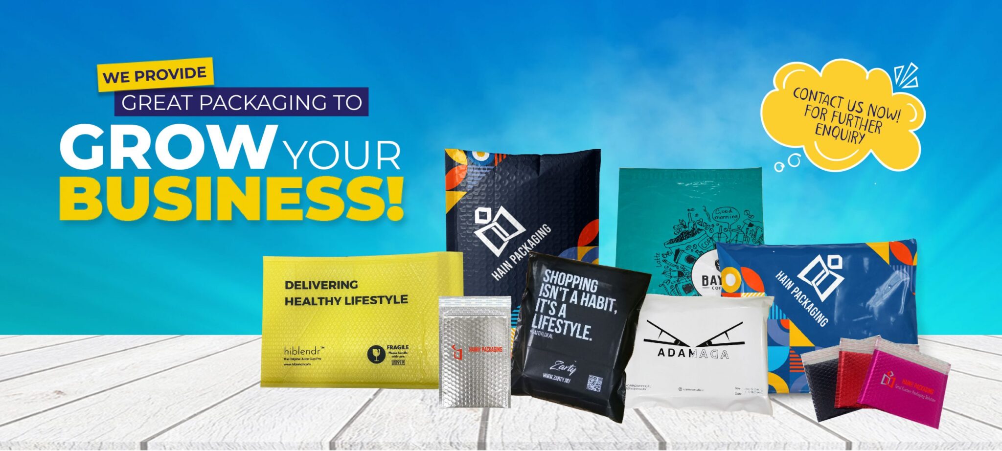 A collection of various padded and unpadded mailers, some with bubble wrap texture, displayed on a white wooden surface against a blue gradient background. Text includes promotional messages and brand names.