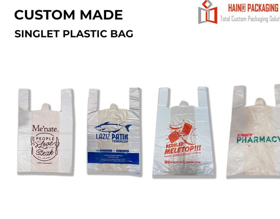 Four white singlet plastic bags with handles, each featuring different custom printing. The first bag has a brown graphic and text. The second bag has a blue fish graphic and text. The third bag has red graphics and text. The fourth bag has green text.