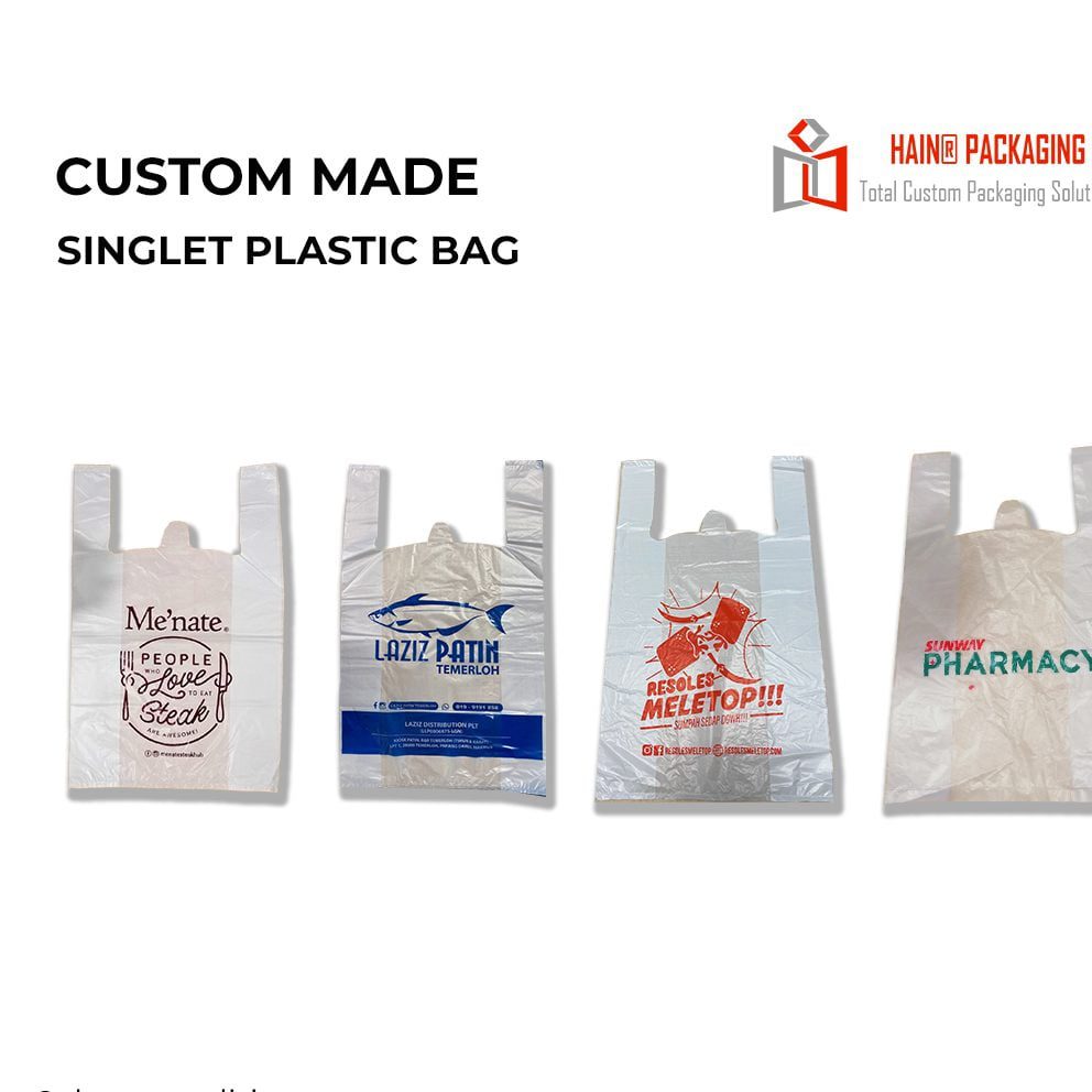 Four white singlet plastic bags with handles, each featuring different custom printing. The first bag has a brown graphic and text. The second bag has a blue fish graphic and text. The third bag has red graphics and text. The fourth bag has green text.