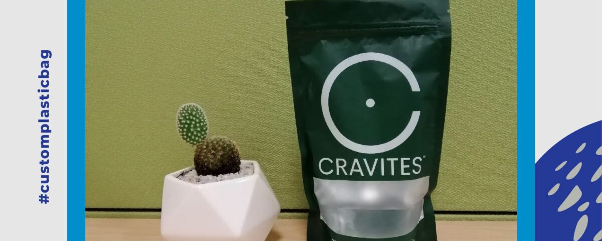 A dark green stand-up pouch bag with a clear window is shown next to a small potted cactus. The bag has white text and graphics, including a large 'C' logo and the brand name 'CRAVITES'.