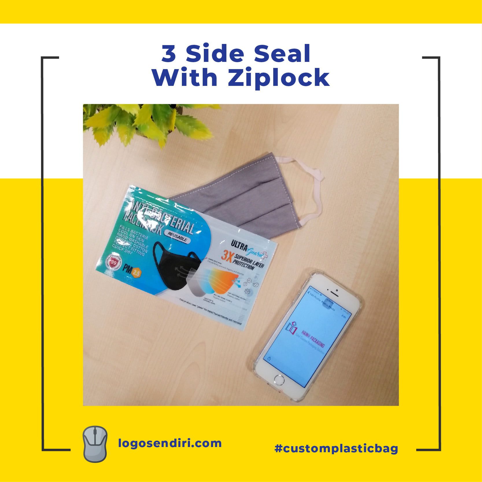 A black antibacterial face mask is shown inside a clear plastic bag with blue and white graphics. A grey fabric face mask lies next to it. A smartphone displaying a packaging company logo is also visible.
