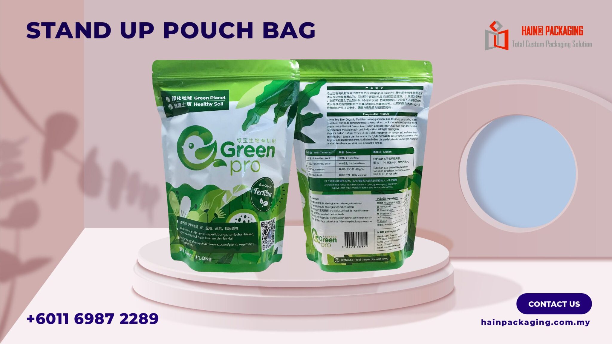 A chemical packaging stand-up pouch with green and white design and a bird logo, printed in multiple languages for Malaysian agrochemical labelling
