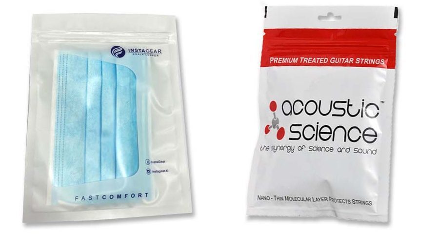 Two sealed pouches are displayed. The left pouch is transparent and contains blue face masks. The right pouch is white with red and black printing, advertising guitar strings.
