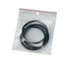 A clear resealable bag containing several black O-rings. The bag has a red zipper closure and a hole at the top for hanging.