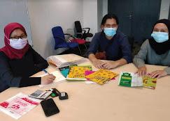 Document and sample presentation sheets being checked against a printed reference