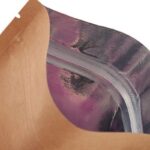 A close-up of a resealable pouch, showing the brown exterior and the shiny, metallic purple interior with a clear zipper closure.